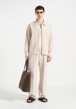 relaxed-fit-twin-pleat-pinstripe-trousers-beige